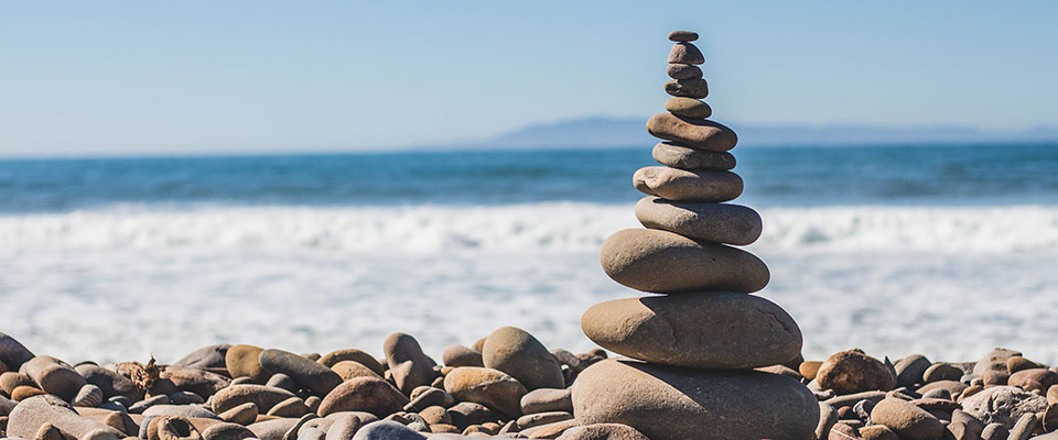 a stones sculpture on a sea shore