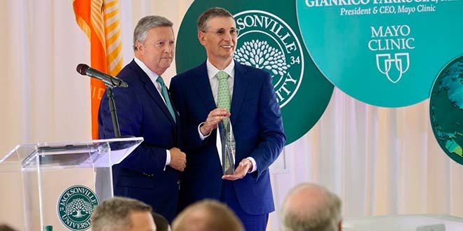 Mayo Clinic President & CEO Gianrico Farrugia, MD, holds the Presidential Global Citizen Award and poses for pictures with President Tim Cost